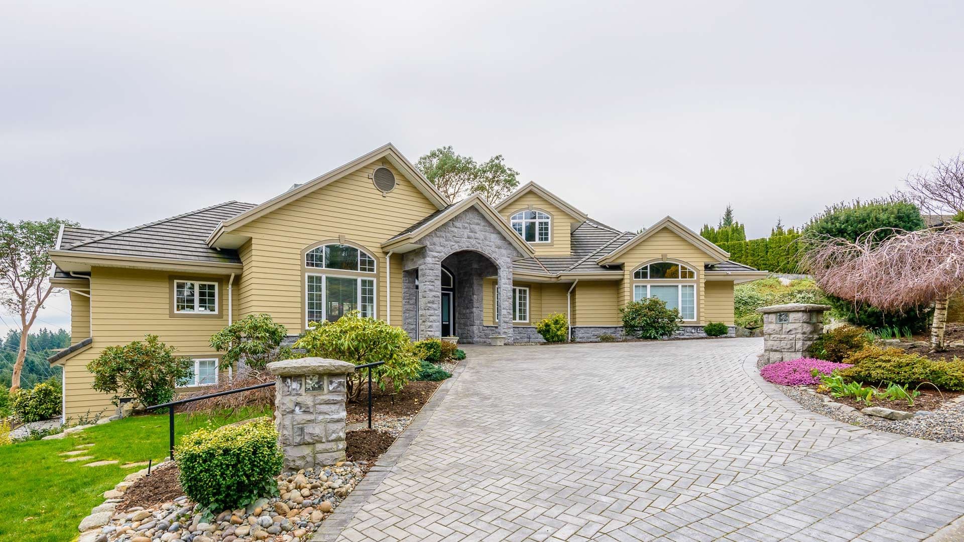 mustard-colored-home-with-long-paved-driveway