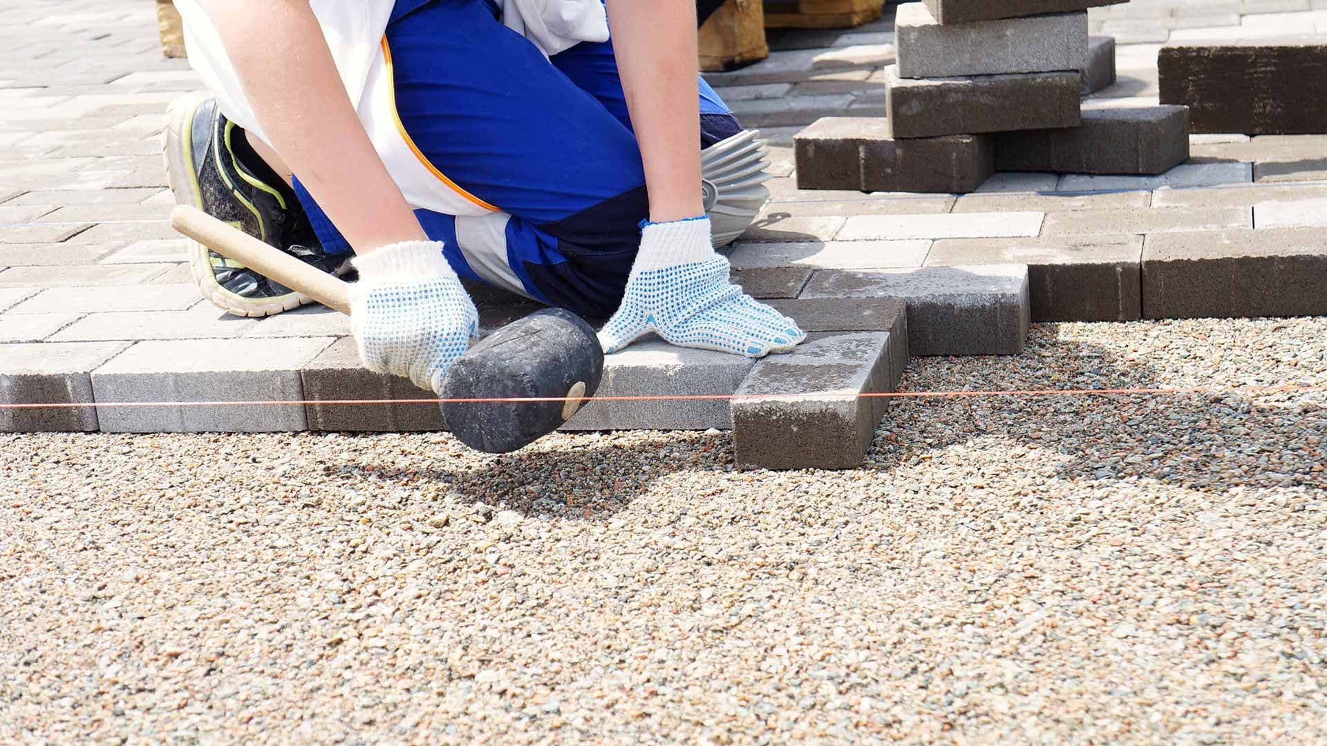 banner-worker-building-paver-patio