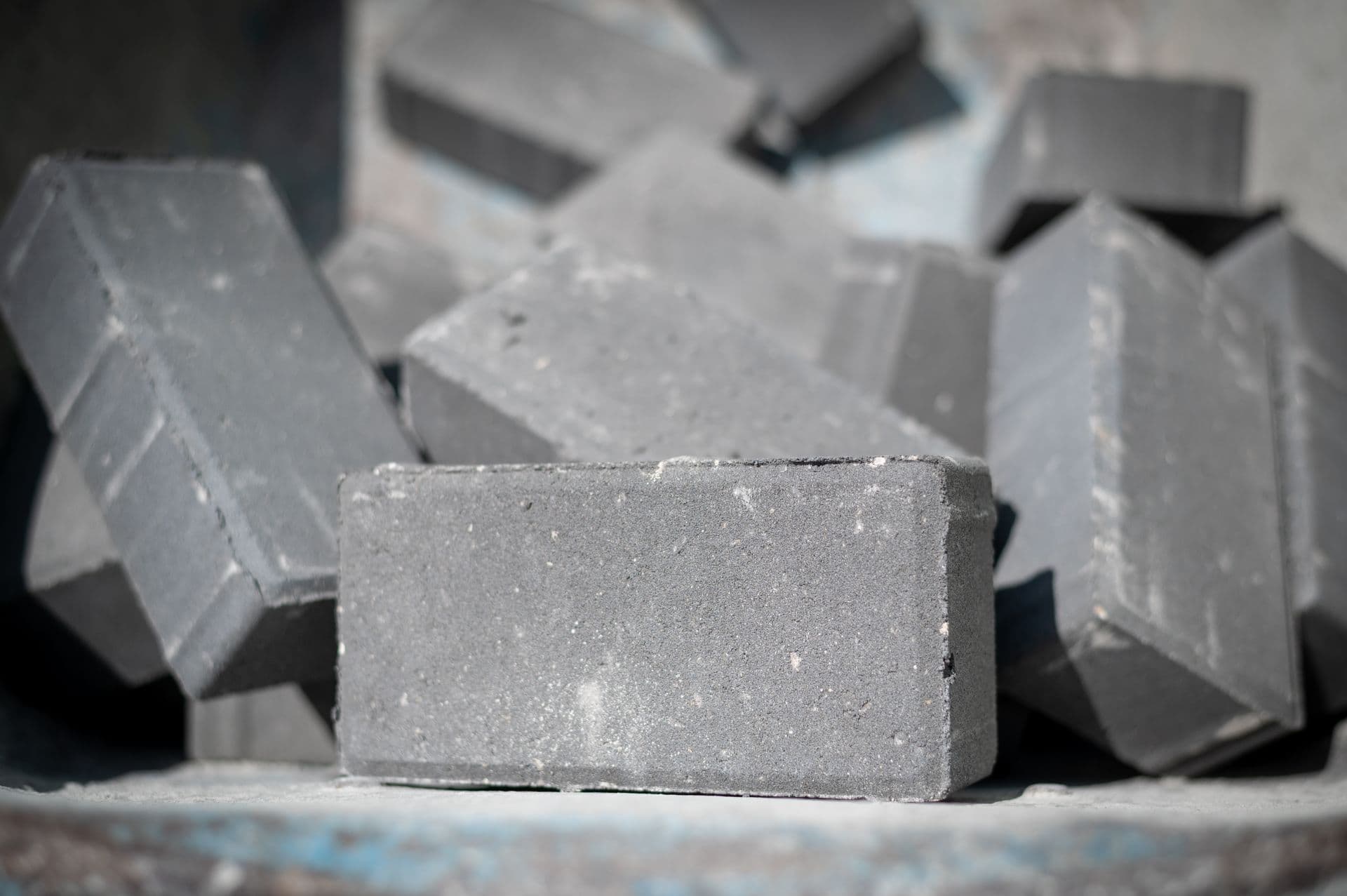 Concrete blocks stacked together, with one block in sharp focus in the foreground